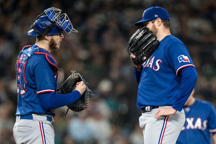 Sep 28, 2023; Seattle, Washington, USA; Texas Rangers starting pitcher Jordan Montgomery (52) and catcher Jonah Heim (28) meet at the mound during the fourth inning against the Seattle Mariners at T-Mobile Park. Mandatory Credit: Stephen Brashear-USA TODAY Sports